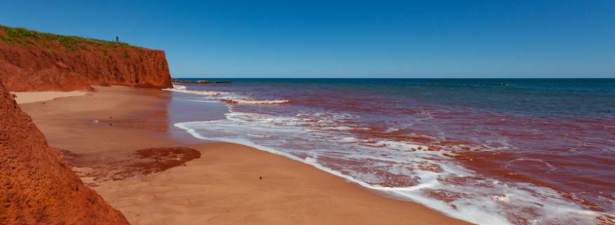Red Pindan Cliff adjoining a turquoise sea at James Price Point, North of Broome in Western Australia